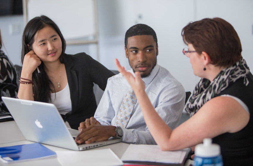 Internships allow you to examine career paths while gaining professional experience that boosts your post-college prospects. interns at work
