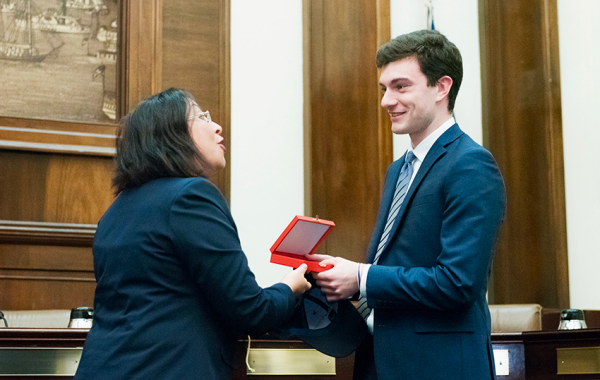 Matthew receiving a gift from his internship
